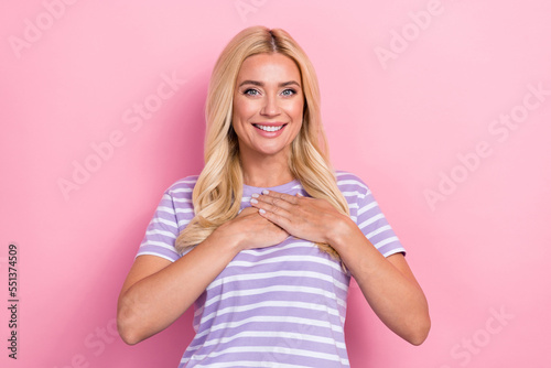 Photo of nice gorgeous mature age blonde hair lady wear stylish striped t-shirt touch chest palms thankful person isolated on pink color background