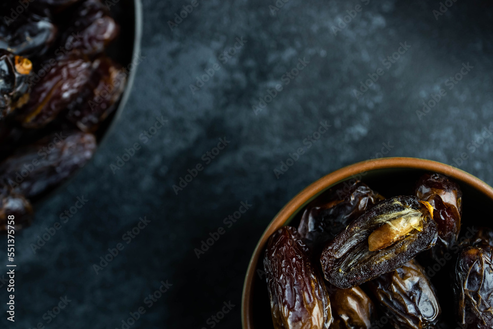 Dates fruit in bowl on dark background. Dried organic Superfood. Dates fruit in bowl on dark background. Dried organic Superfood.