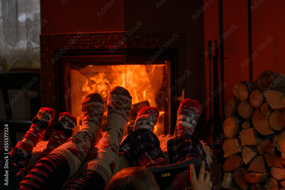 Naklejka premium Family of Feet warming at a fireplace
