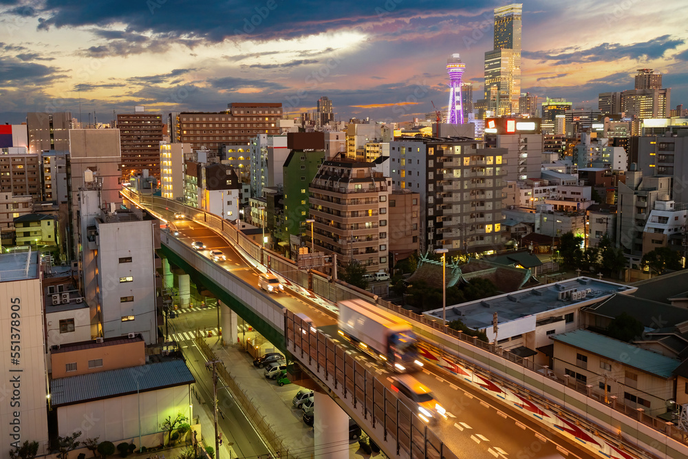 Evening Japan. Panorama of Osaka. Car overpass in Japanese city. Japanese architecture. Evening cityscape of Osaka. Sunset over city of Japan. Asian architecture. Osaka view from quadcopter