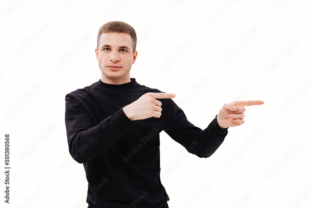 a man in black clothes points his finger at something on a white background. a man in black clothes points his finger at something on a white background.