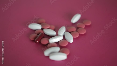 A man collect Pills and capsules on a colorful surface in a stochastic way photo