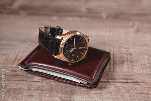wrist watch and wallet on the table