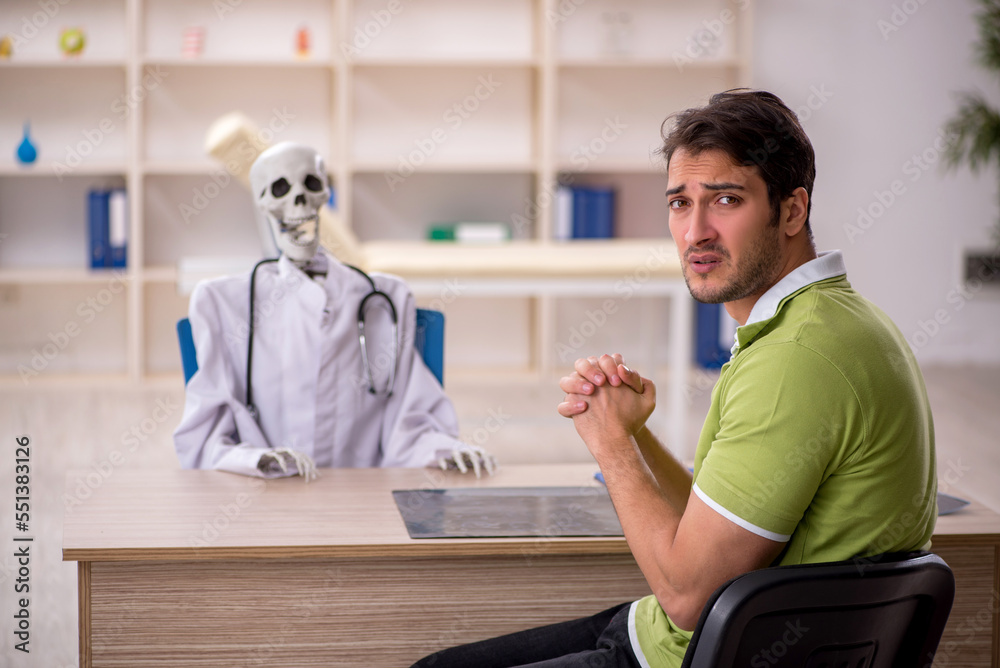 Young male patient visiting skeleton doctor