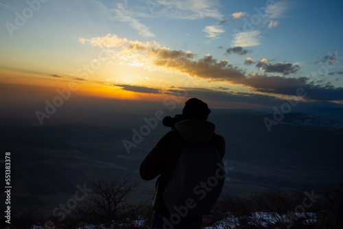 the photographer photographs the sunset in the evening