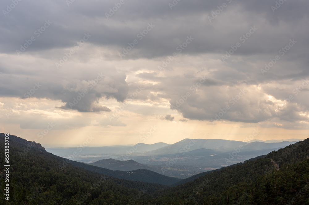 Aerial View of Valley from the Mountains with Large Storm Clouds Above