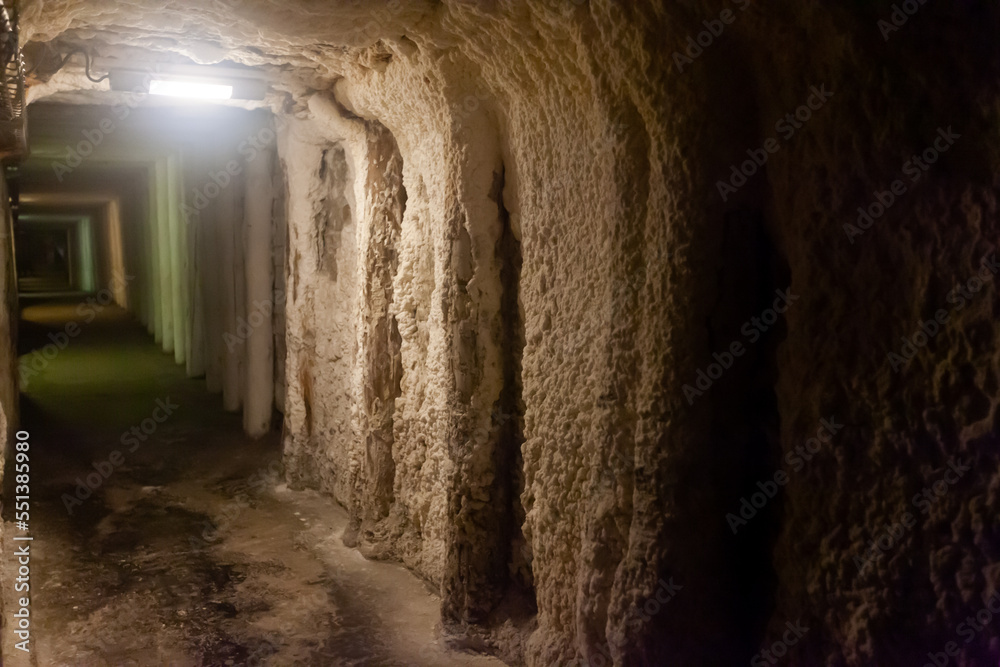 Empty illuminated long tunnels in old mines