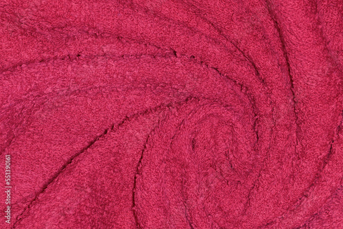 Crumpled fabric texture of towel close up in Viva Magenta - trendy color of year 2023.