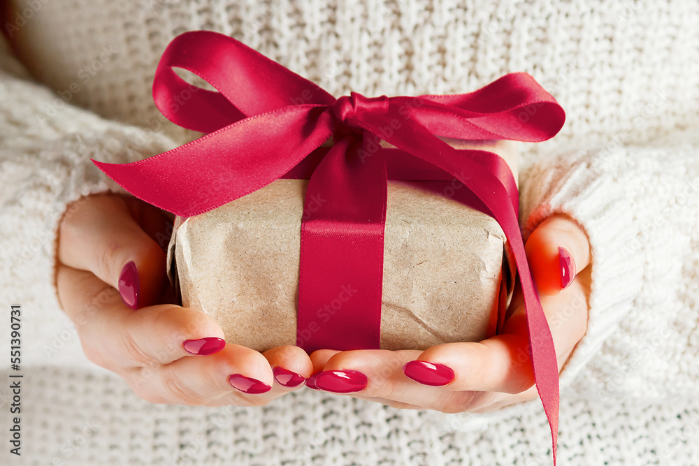 Woman holding box in craft paper. Color of the year 2023 - Viva Magenta Woman holding box in craft paper. Color of the year 2023 - Viva Magenta