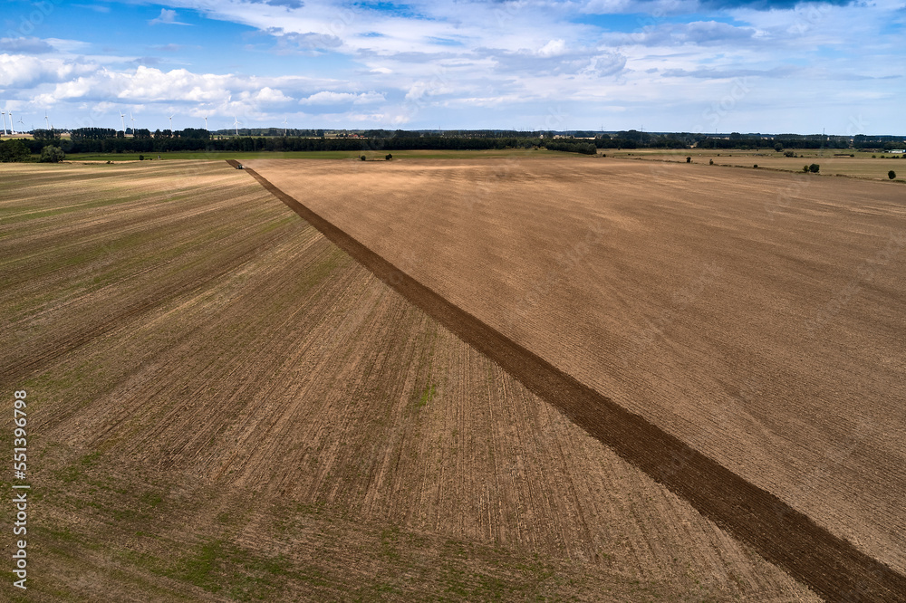 plowing farm after harvesting with vehicle