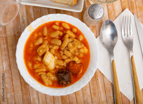 Tasty stew of asturian beans in gravy with various sausages photo