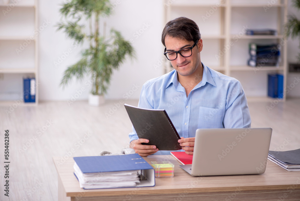 Young male employee working in the office
