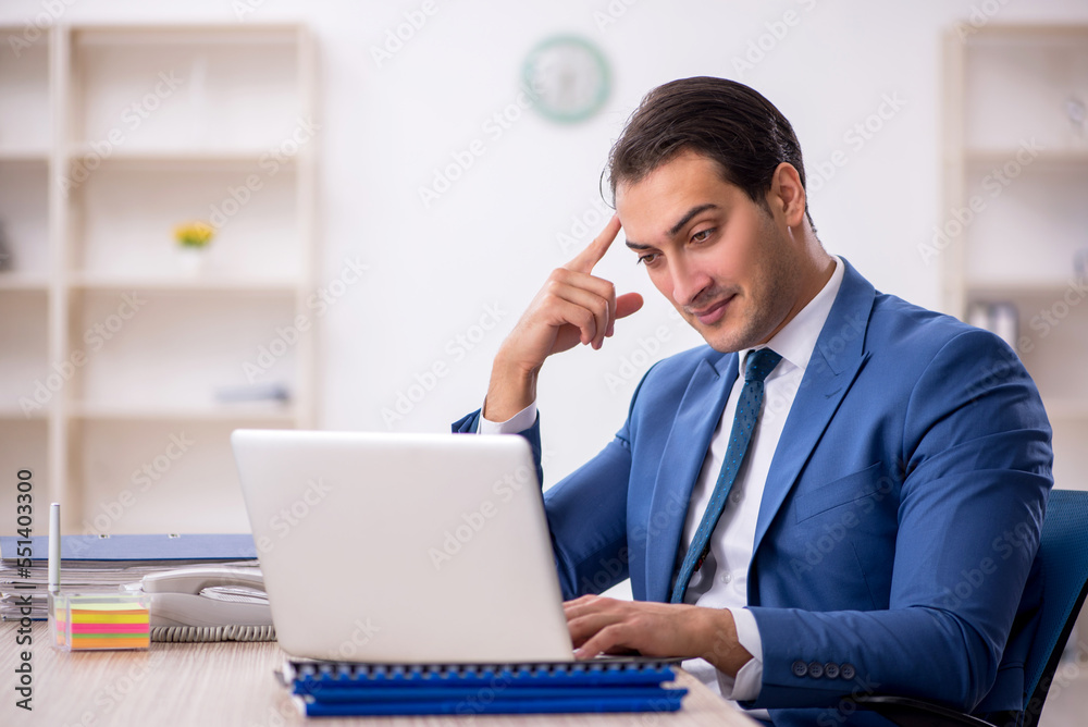 Young male employee working in the office