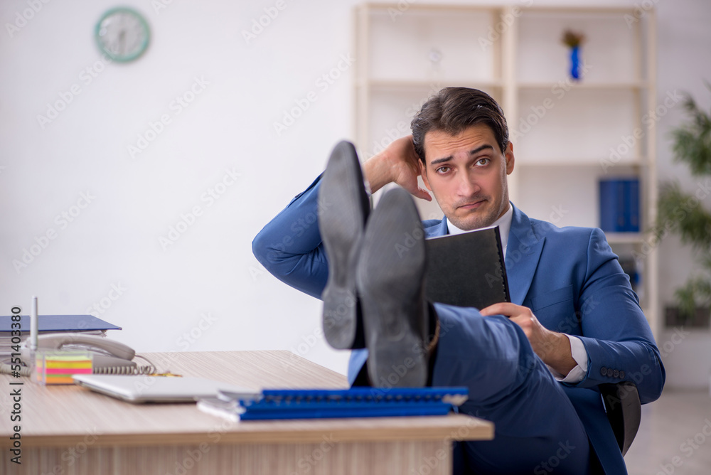 Young male employee working in the office Young male employee working in the office