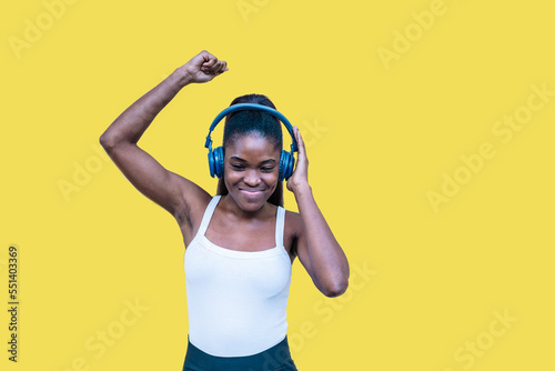 Black woman listening to music and dancing photo