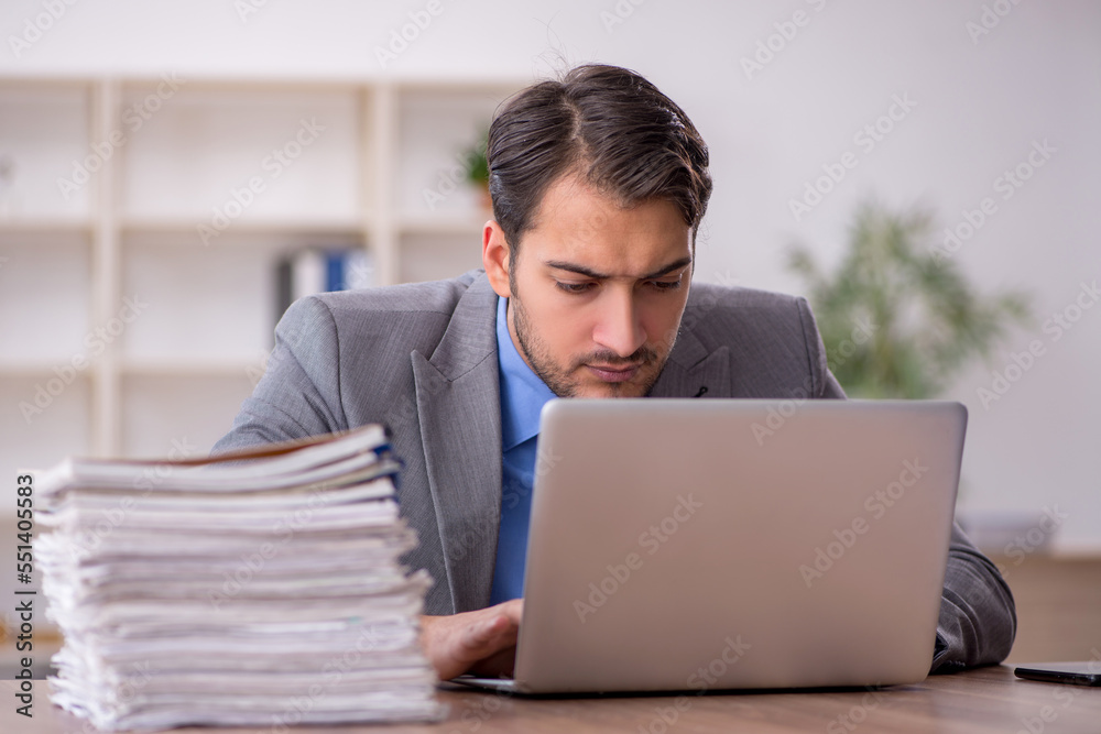 Young male employee working in the office Young male employee working in the office