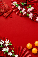 Happy Chinese New Year 2023 year of the rabbit concept. Chinese New Year banner design with tangerines, blossom flowers, money pockets, oriental asian paper fans on red background