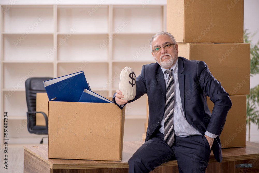 Old male employee in office relocation concept Old male employee in office relocation concept