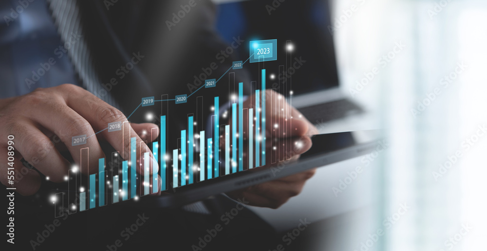 Business target and achievement in 2023 new year resolution statistics graph rising revenue, planning and strategy. Businessman using tablet with financial graph growth report, business development Business target and achievement in 2023 new year resolution statistics graph rising revenue, planning and strategy. Businessman using tablet with financial graph growth report, business development