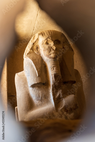 Life-sized statue of Djoser inside the Serdab ('cellar') - a limestone box near the northern entrance of the pyramid of Djoser in Saqqara, Egypt.  Travel and history.