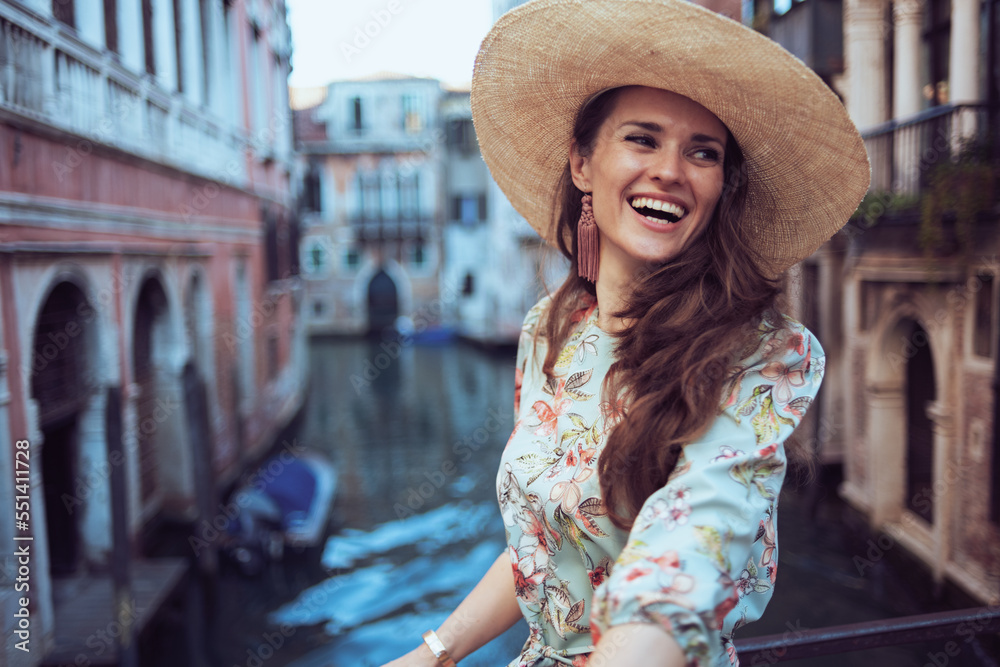 happy trendy woman in floral dress exploring attractions