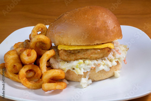 fish fillet  on cole slaw with curley  fries photo