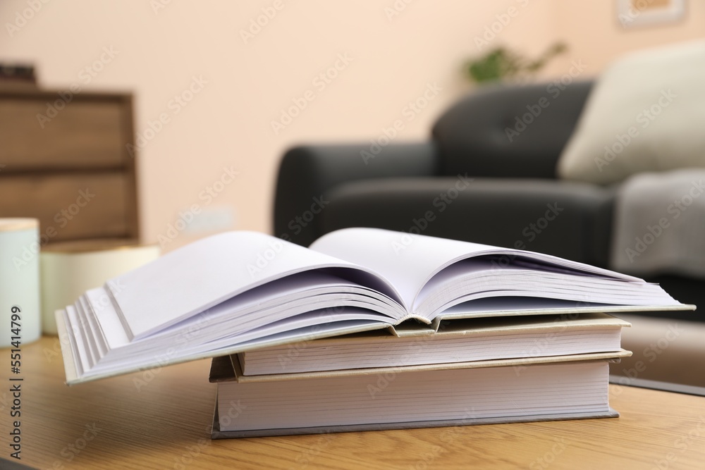 Books on wooden table in living room Books on wooden table in living room
