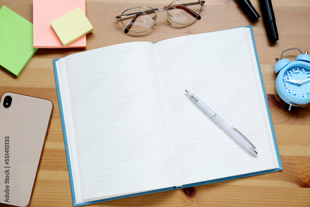 Empty notebook. smartphone, glasses and stationery on wooden table, flat lay Empty notebook. smartphone, glasses and stationery on wooden table, flat lay