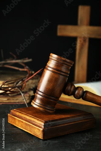 Wooden judge gavel on table against black background
