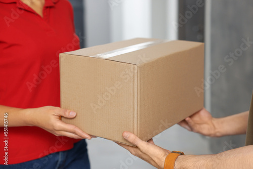 Wallpaper Mural Courier giving parcel to customer in hallway, closeup Torontodigital.ca