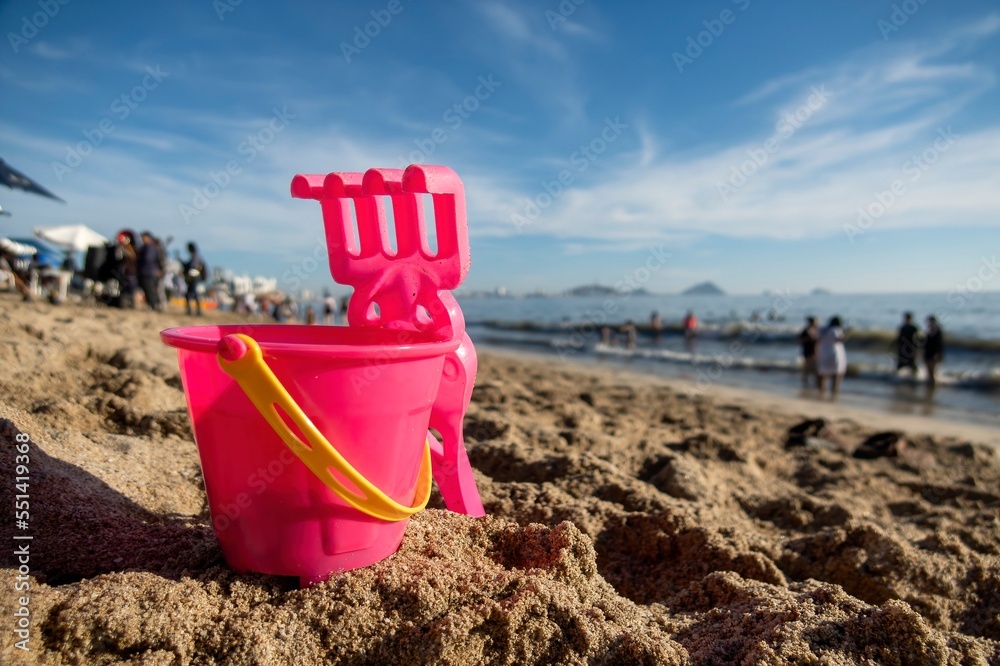 Bucket and scoop in the sand on the beach on vacation Bucket and scoop in the sand on the beach on vacation