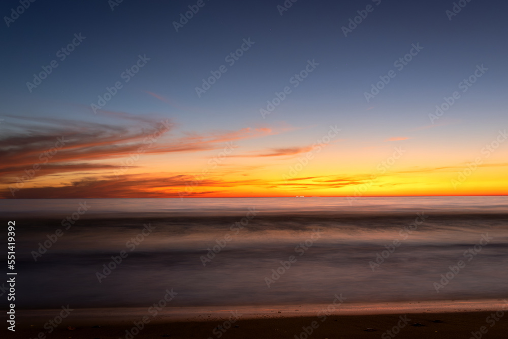 Yellow sunset on the beach. seascape for background. colorful sky. beautiful water reflection. sunlight