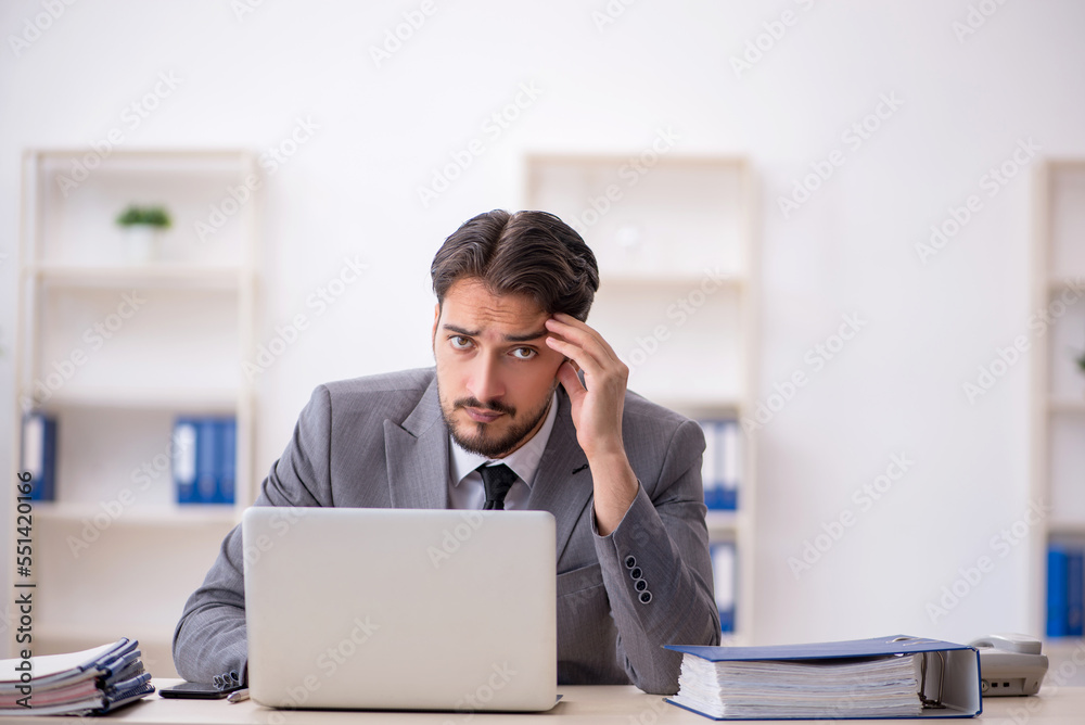 Young male employee working in the office Young male employee working in the office