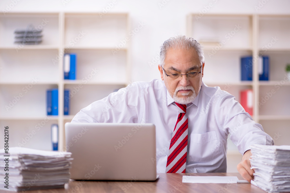 Old male employee and too much work in the office Old male employee and too much work in the office