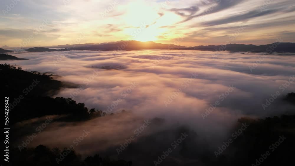 High angle view drone view of fog in rainy season over mountains,Beautiful sunrise sky clouds for create nature video scene. 4K High quality footage High angle view drone view of fog in rainy season over mountains,Beautiful sunrise sky clouds for create nature video scene. 4K High quality footage