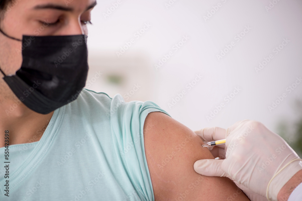 Fototapeta premium Young male patient visiting old male doctor in vaccination conce