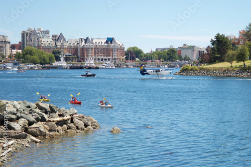 Kayakers and seaplane leaving the harbour on a sunny day, followed by patrol boat. © Alain Bechard