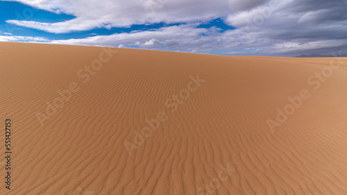 Wide sandy desert patterned plateau during bright sunny day in Canary Islands, Corralejo, Spain