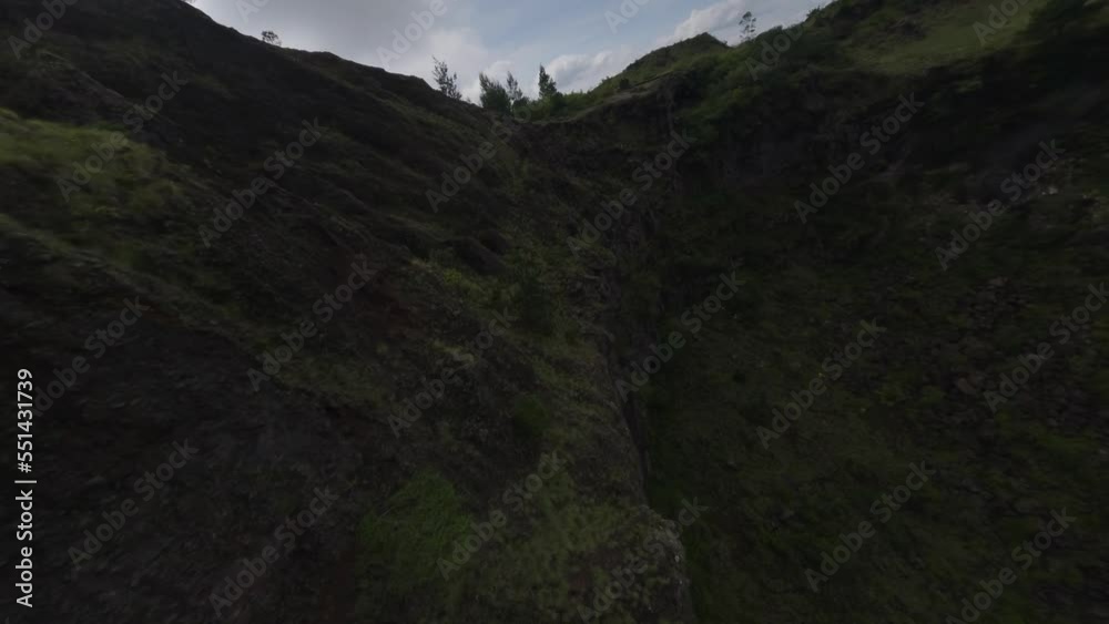 Crag volcano crater stone texture with greenery plant picturesque nature mountain landscape aerial view. FPV sports drone shot cliff cinematic alpine valley volcanic epic scenery environment journey Crag volcano crater stone texture with greenery plant picturesque nature mountain landscape aerial view. FPV sports drone shot cliff cinematic alpine valley volcanic epic scenery environment journey