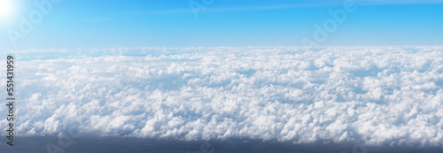 Blue sky background with white clouds from the airplane windows