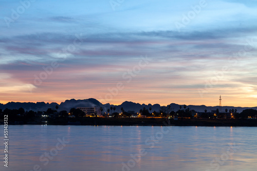 View of Khammouane Province  Laos  a small town on the banks of the Mekong River with many mountains in the background  early in the morning.