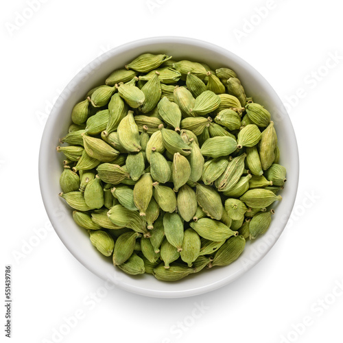 Cardamom pods in white bowl isolated on white. Top view.