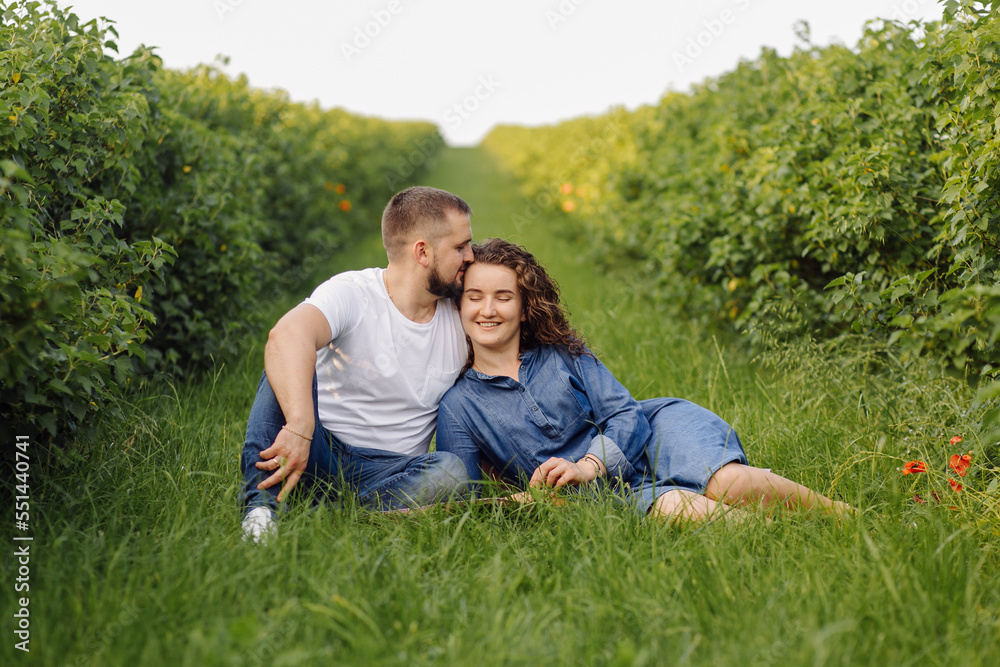 young couple sitting on grass and relaxing young couple sitting on grass and relaxing