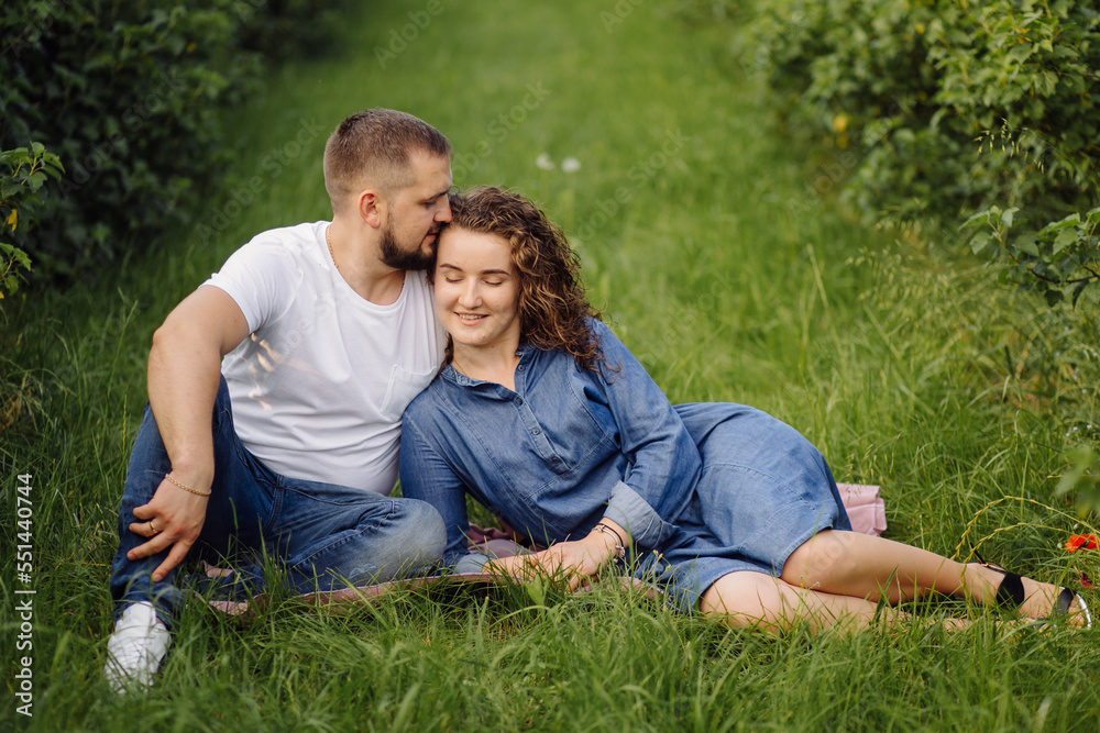 young couple sitting on grass and relaxing young couple sitting on grass and relaxing