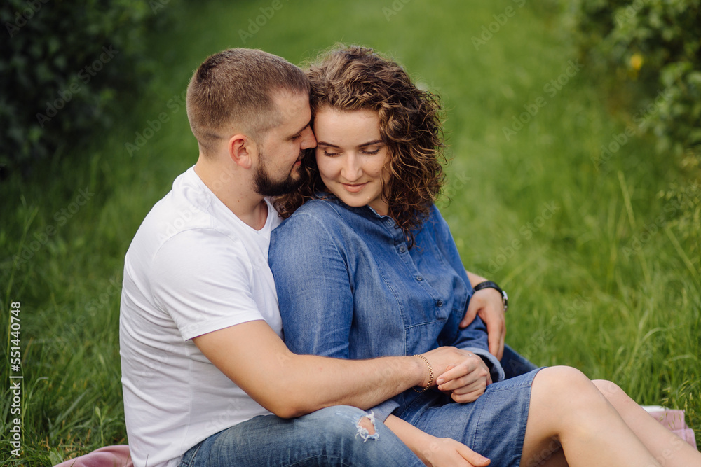 young couple sitting on grass and relaxing