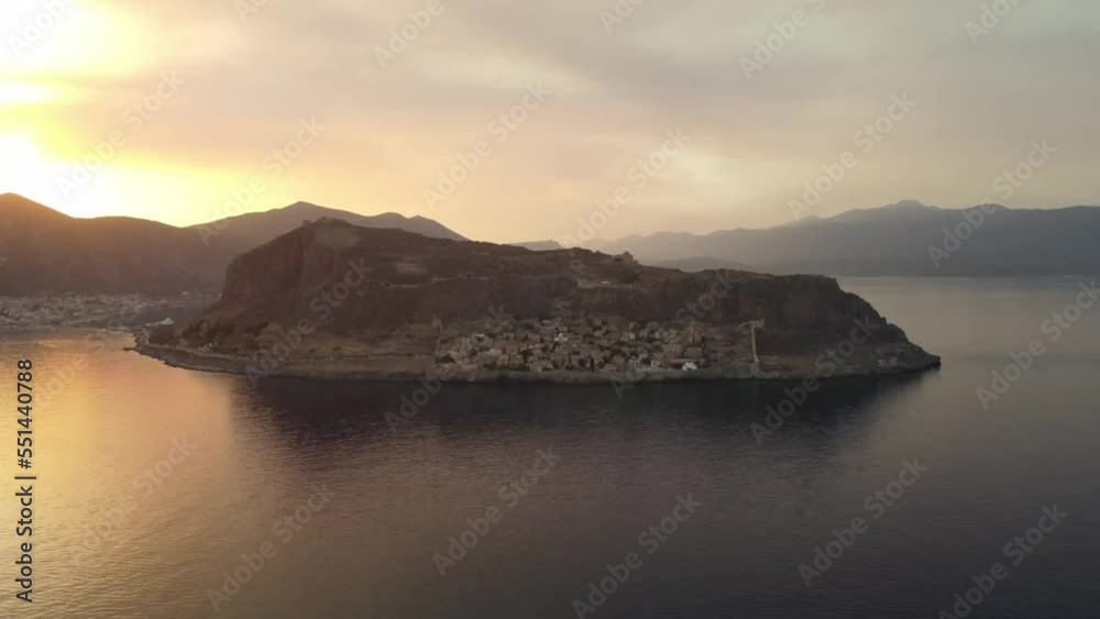 Distant, establishing shot of Monemvasia. Drone coming in closer. Mountain range. Distant, establishing shot of Monemvasia. Drone coming in closer. Mountain range.