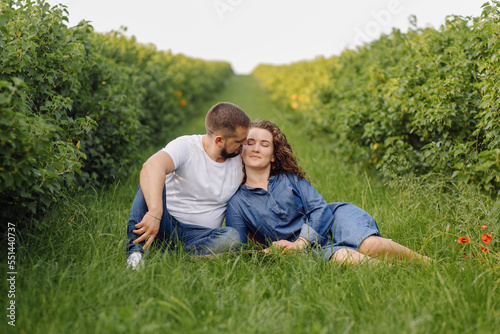 young couple sitting on grass and relaxing © andriyyavor