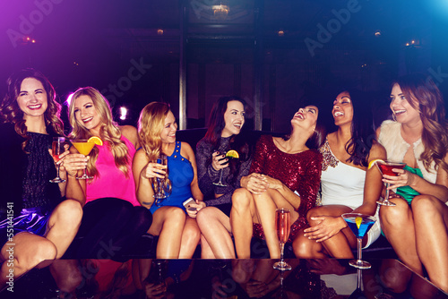 Cocktail, happy or friends at a vip party laughing at funny joke or drinking alcohol at social event celebration. Night, luxury or excited group of women with champagne drinks to celebrate new years