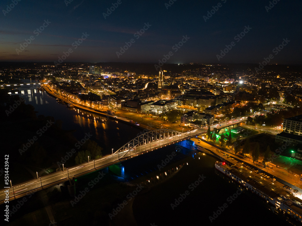 Arnhem city in the Netherlands by night Aerial drone. City center, rhine river and church, Eusebiuskerk, john frost bridge, skyline and infrastructure, city center.
