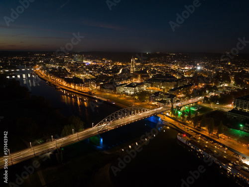 Arnhem city in the Netherlands by night Aerial drone. City center, rhine river and church, Eusebiuskerk, john frost bridge, skyline and infrastructure, city center. © Sepia100